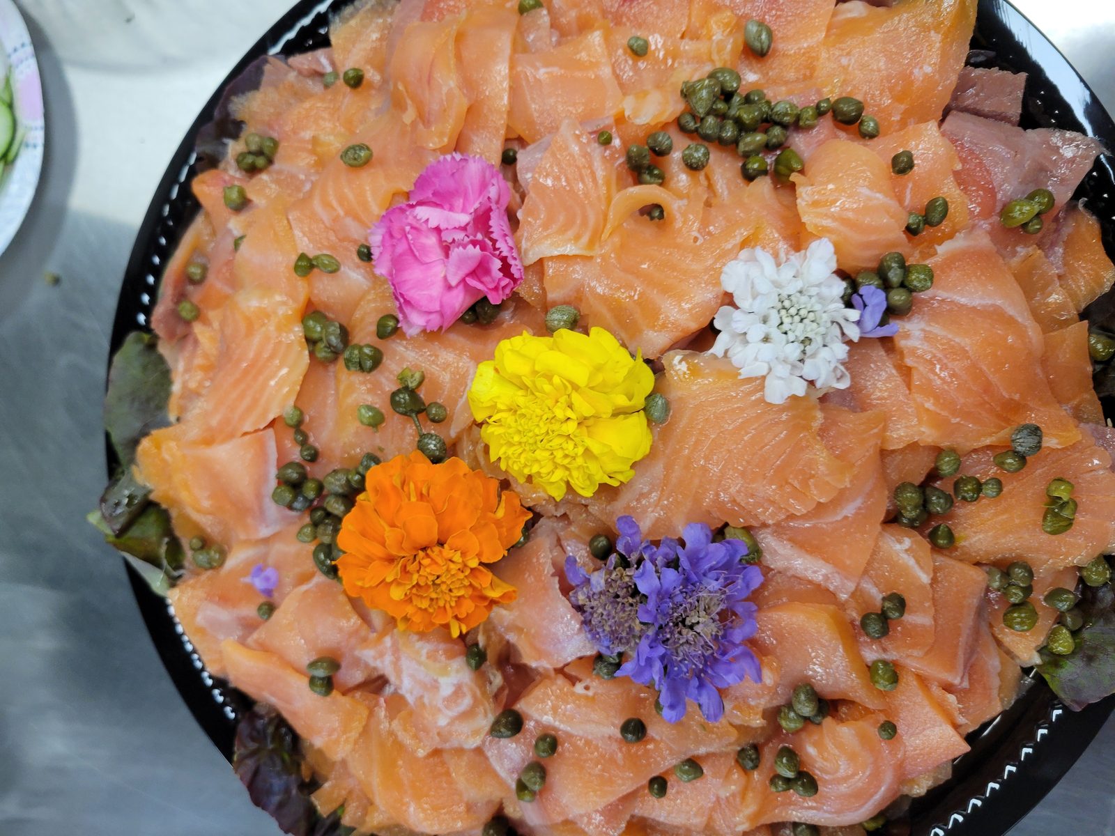 Smoked salmon platter with edible flowers